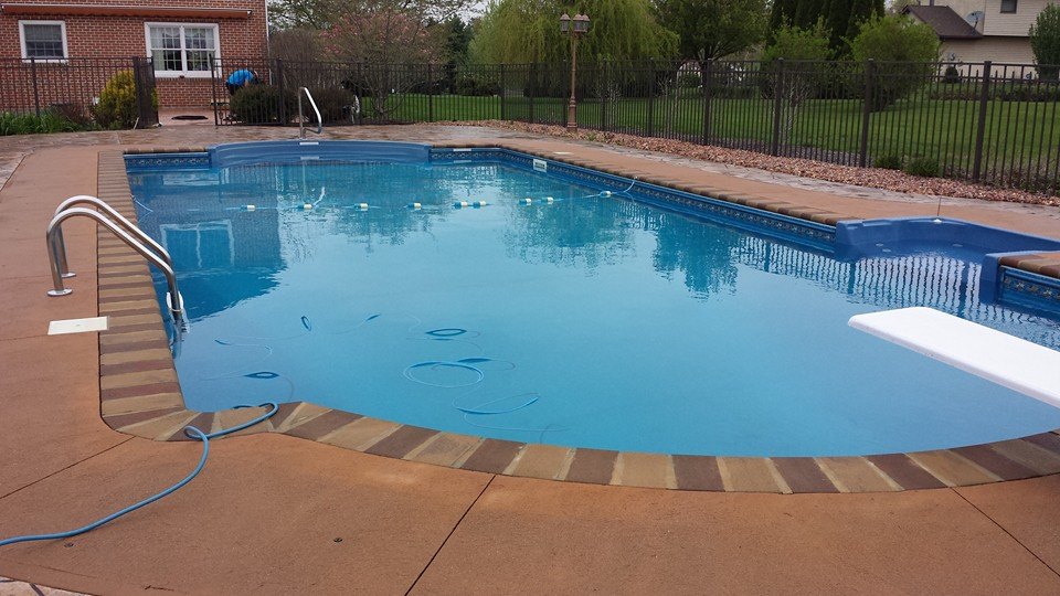 Marano pool from alternate view showing landscaping and pool deck design