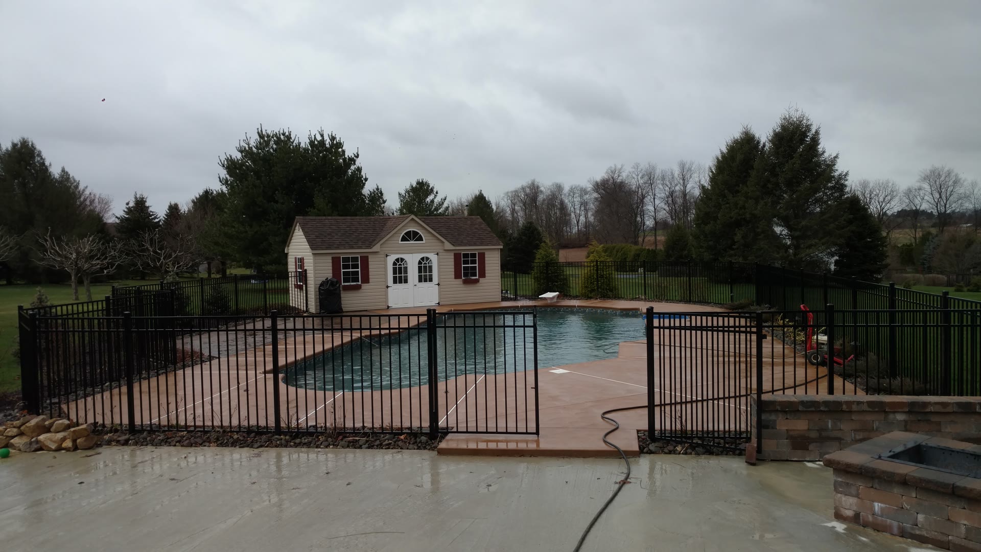 Ahner Pools crew excavating and shaping an inground pool in a residential backyard