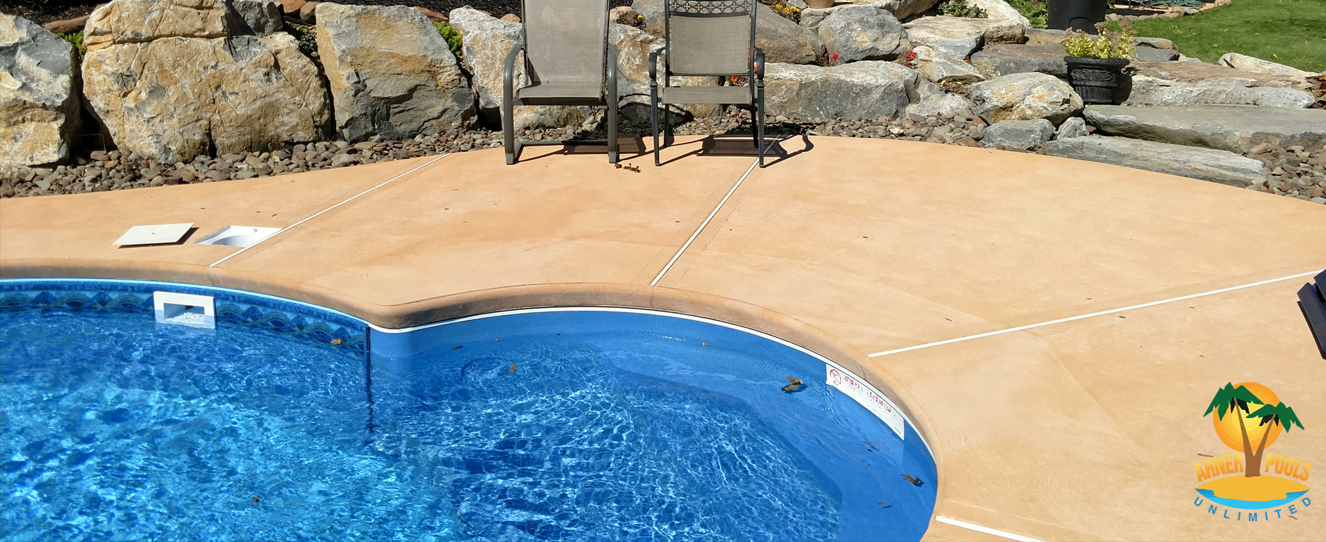 Completed custom inground pool with stone patio and landscaping in the Lehigh Valley